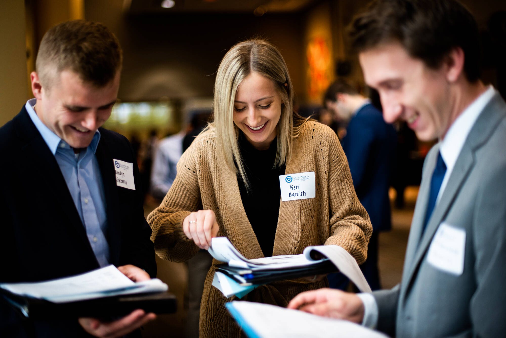 Three students smiling at the career fair